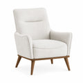 Sillón tapizado en tela color crema con estructura de madera